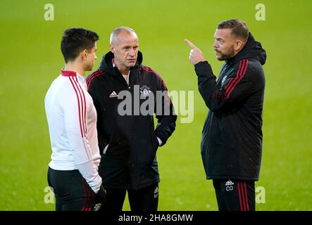 Manchester United fitness coach Charlie Owen (right), first team coach Martyn Pert and first team coach Eric Ramsay have a conversation ahead of the Premier League match at Carrow Road, Norwich. Picture date: Saturday December 11, 2021. Stock Photo
