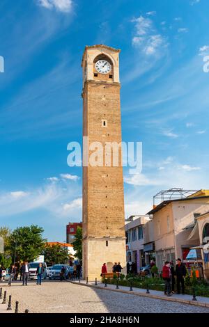 ADANA, TURKEY - DECEMBER 4, 2021: BUYUK SAAT KULESI (English: Great Clock Tower) is a historical clock tower in Adana. Tower seems from old bazaar str Stock Photo