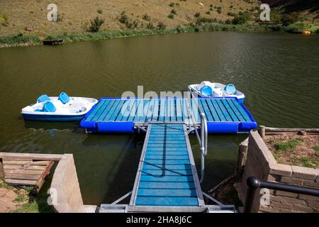 Two paddle boats connected to a floatable jeti on a lake Stock Photo