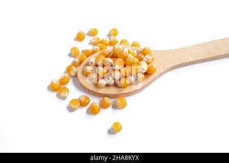 Top view corn kernels, wooden spoon with corn kernels isolated on white background. Stock Photo