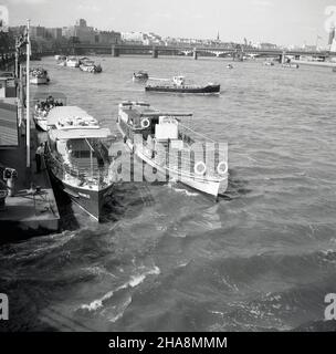 1958, historical, river pleasure boats of the era at the jetty at Westminster pier, on the river Thames at Westminster Bridge, London, England, UK. The Wincomblee (in 1960 renamed Tower Belle) is by the jetty and another boat, the Marchioness, beside it. These traditonal crusiers ran public pleasure trips downstream to Greenwich and upriver, sometimes as far as Hampton Court. Stock Photo