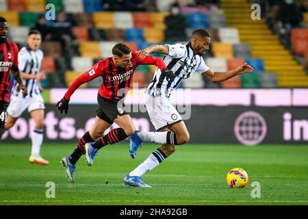 Udine, Italy. 11th Dec, 2021. Udinese's Norberto Bercique Gomes Betuncal in action against Milan's Ismael Bennacer (Milan) during Udinese Calcio vs AC Milan, italian soccer Serie A match in Udine, Italy, December 11 2021 Credit: Independent Photo Agency/Alamy Live News Stock Photo