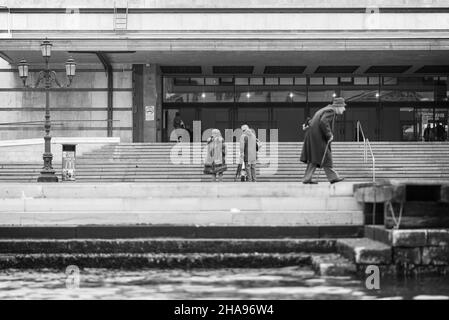 An old man strolls along the Grand Canal in from the the train station in Venice Stock Photo