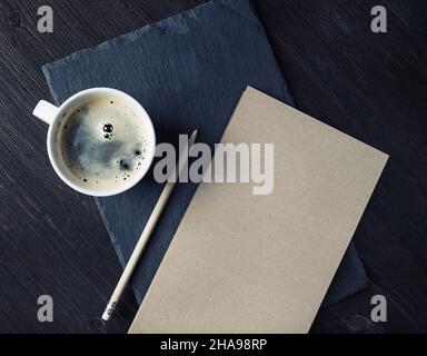 Blank kraft sketchbook, pencil and coffee cup. Stationery template. Stock Photo