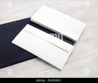 Photo of two blank white envelopes. Front and back side. Template for branding identity. Stock Photo