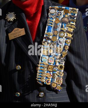 A member of the Daughters of the American Revolution wears her DAR pins, ribbons and sash at a commemorative event in Santa Fe, New Mexico. Stock Photo