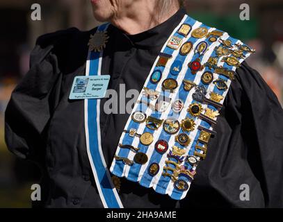 A member of the Daughters of the American Revolution wears her DAR pins, ribbons and sash at a commemorative event in Santa Fe, New Mexico. Stock Photo