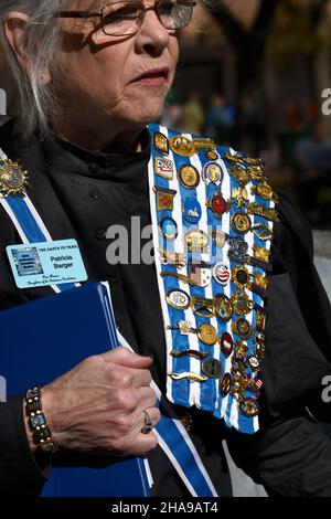 A member of the Daughters of the American Revolution wears her DAR pins, ribbons and sash at a commemorative event in Santa Fe, New Mexico. Stock Photo