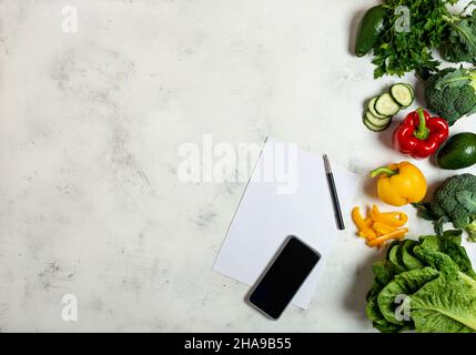Open Notebook and Fresh Vegetables Background diet copy space Stock Photo