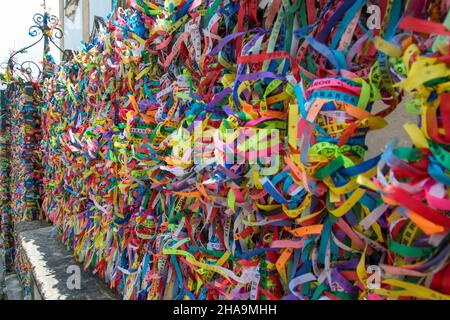 Thousands of colored ribbons tied to a gate. Salvador, Bahia, Brazil. Stock Photo