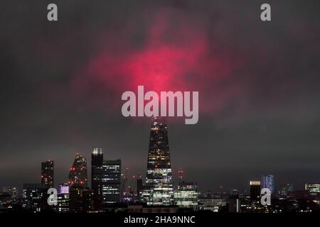 London, UK. 11th December, 2021. UK Weather: Colourful Shard Lights seen breaking through low mist on Saturday evening. The unique annual light show is designed to celebrate the spirit of togetherness. Credit: Guy Corbishley/Alamy Live News Stock Photo
