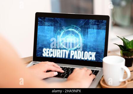 Handwriting text Security Padlock. Concept meaning hardened steel body and double locking shackle of extra one Hand Typing On Laptop Next To Coffee Stock Photo