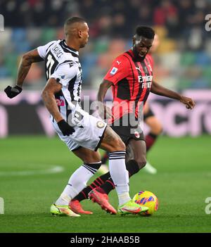 Udine, Italy. 11th Dec, 2021. AC Milan's Tiemoue Bakayoko (R) vies with Udinese's Walace during a Serie A soccer match between Udinese and AC Milan in Udine, Italy, Dec. 11, 2021. Credit: Str/Xinhua/Alamy Live News Stock Photo