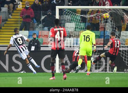 Udine, Italy. 11th Dec, 2021. Udinese's Beto (1st L) scores his goal during a Serie A soccer match between Udinese and AC Milan in Udine, Italy, Dec. 11, 2021. Credit: Str/Xinhua/Alamy Live News Stock Photo