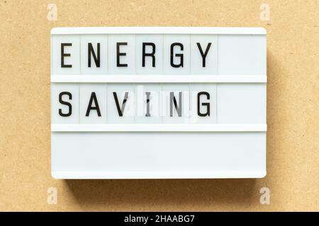 Lightbox with word energy saving on wood background Stock Photo