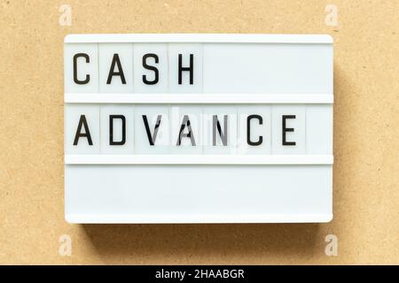 Lightbox with word cash advance on wood background Stock Photo