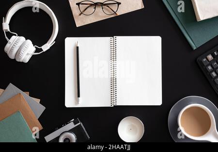 Open blank notebook on black background, flat lay. Stock Photo