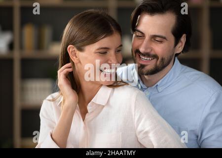 Happy excited young couple in love having fun at home Stock Photo