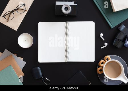 Open blank notebook on black background, flat lay. Stock Photo