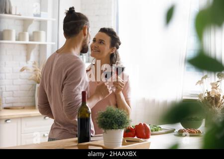 Happy sweet dating couple in love flirting, drinking red wine Stock Photo
