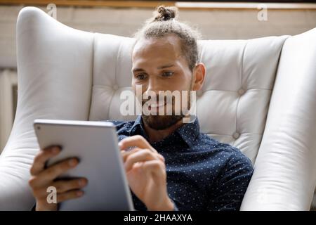 Happy young hipster blogger guy using tablet computer Stock Photo