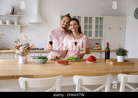 Happy young millennial couple preparing dinner head shot portrait Stock Photo
