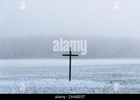 Big black cross on a field in winter Stock Photo