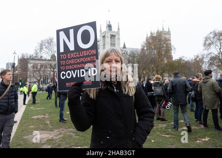 A protestor seen holding a placard that says 'no to exclusion, to checkpoints, to discrimination, covid ID' during the demonstration.Jointly led by Big Brother Watch and Migrant Organise, protestors gathered to voice discontent in relation to the UK government's attempt to make vaccine passports and other forms of COVID IDs a requisite for large scale events and entry into public spaces. The group seeks to clearly delineate the difference between anti vaccine passports specifically and anti vaccines, with which they identify with the former. Stock Photo