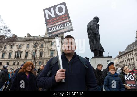 A protestor seen holding a placard that says 'No to exclusion, to checkpoints, to discrimination, COVID ID' during the demonstration.Jointly led by Big Brother Watch and Migrant Organise, protestors gathered to voice discontent in relation to the UK government's attempt to make vaccine passports and other forms of COVID IDs a requisite for large scale events and entry into public spaces. The group seeks to clearly delineate the difference between anti vaccine passports specifically and anti vaccines, with which they identify with the former. Stock Photo