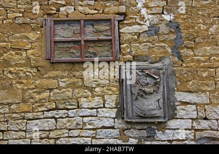 Two walled old windows in a stone wall Stock Photo