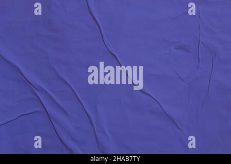 Old grunge ripped torn collage creased crumpled paper placard texture background tonned in color the year 2022 very peri Stock Photo