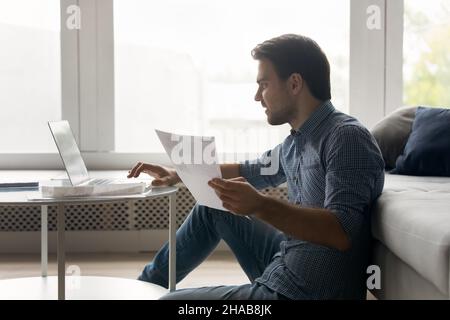 Man working on laptop, do paperwork at quarantine at home Stock Photo