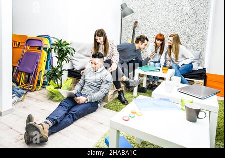 Young people employee workers having break in start up office - Human resources business concept with creative entrepreneurs having fun together Stock Photo