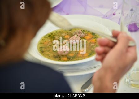 A plate of liver dumpling soup with chives Stock Photo