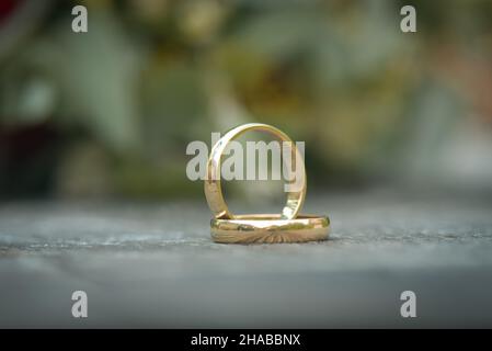 A pair of gold wedding rings with bokeh background Stock Photo