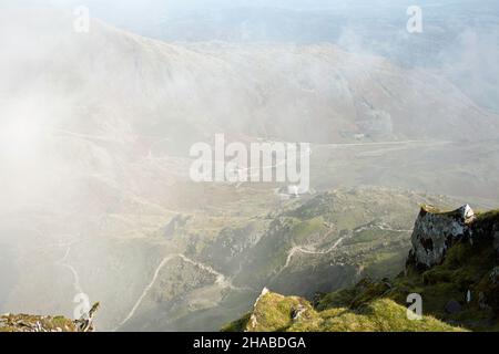 Mist swirling over the path leading up from the Copper Mines Valley to the summit of the Old Man of Coniston the Lake District Cumbria England Stock Photo