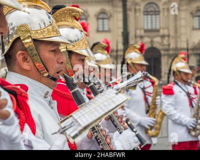 Lima, Peru - December, 2019: Close-up for a man playing the flute. The guards of the Presidential Palace give a concert in the Plaza de Armas before t Stock Photo