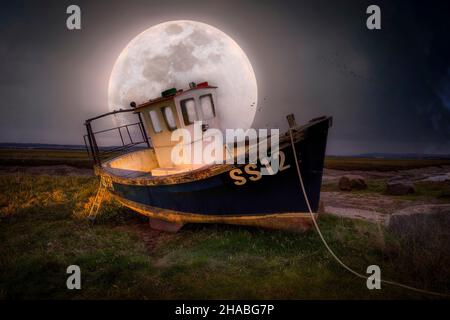 Editorial Swansea, UK - September 30, 2018: Moonlight compilation of an old fishing boat in the cockle picking village of Penclawdd in Swansea, South Stock Photo