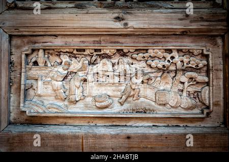 Close-up detail of ancient classic wooden door panel decorated with typical Chinese architecture style pattern and woodcarving Stock Photo