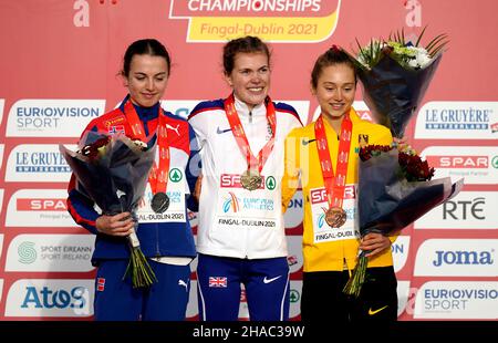 Great Britain's Megan Keith (centre) celebrates with their gold medal after winning the Women's Under 20 event alongside second placed Norway's Ingeborg Ostgard wither silver medal and third placed Germany's Emma Heckel with her bronze during the SPAR European Cross Country Championships 2021 at Fingal-Dublin in Ireland. Picture date: Sunday December 12, 2021. Stock Photo