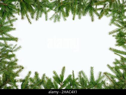 Simple Christmas frame made of fir branches on white background Stock Photo