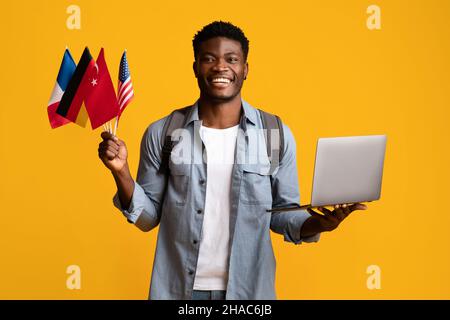 Positive african american young man learning foreign languages online Stock Photo
