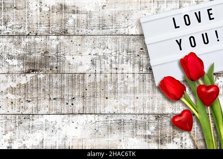 Valentines Day decoration. Red hearts and tulip flowers flat lay background Stock Photo