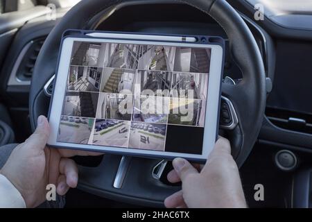 man using digital tablet for monitoring CCTV cameras Stock Photo