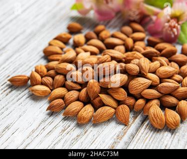 The kernels of apricot pits on a old wooden background Stock Photo