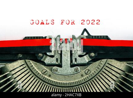 Vintage typewriter with sample text GOALS FOR 2022. Red words on white paper background Stock Photo