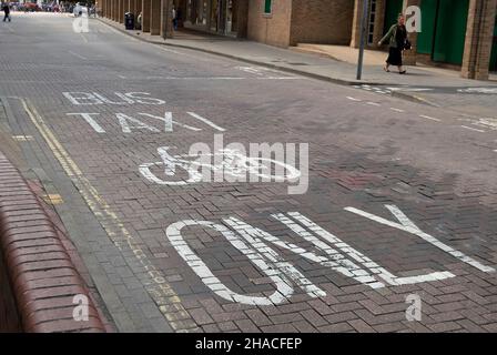 road markings indicating use restricted to buses, taxis and cyclists in  the centre of kingston upon thames, surrey, england Stock Photo