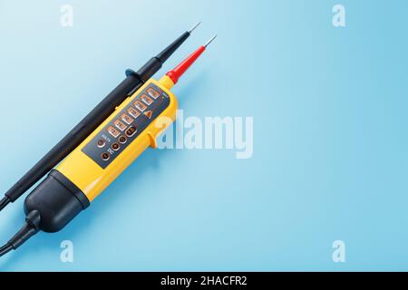 Two-pole voltage indicator close-up on a blue background. Testing and verification of electrical networks Stock Photo