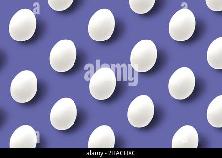 Easter white eggs with shadows on purple trendy background. Pattern, hipster design. Flat lay. Stock Photo