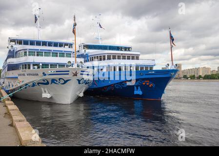 SAINT PETREBURG, RUSSIA - JUNE 22, 2018: Two cruise ships moored on the Neva river on a cloudy June day Stock Photo
